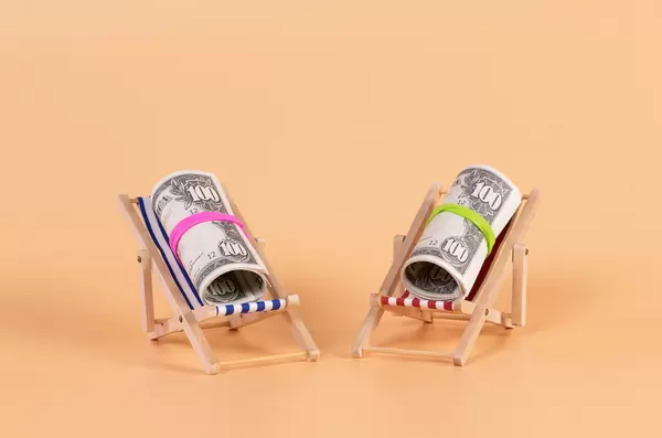 Rolls of dollar banknotes lying in a deck chair