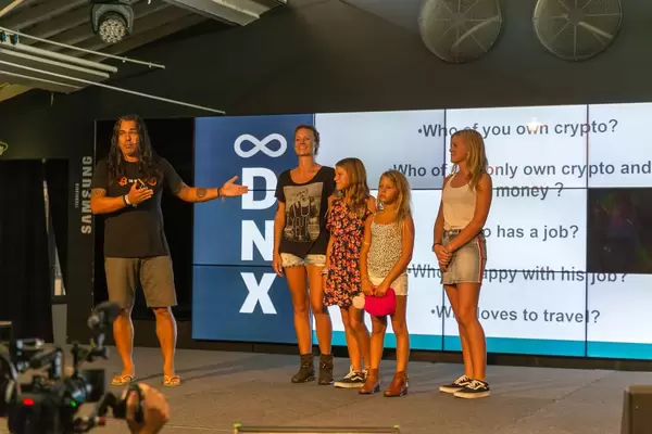Romaine Taihuttu and Didi Taihuttu with Bitcoin family on stage of DNX Festival in Lisbon