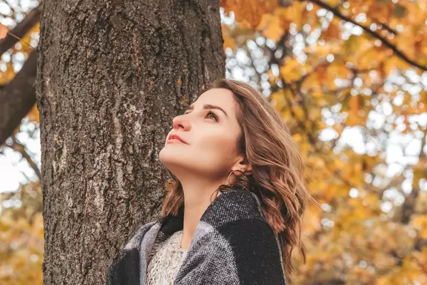 Romantic girl in autumn landscape