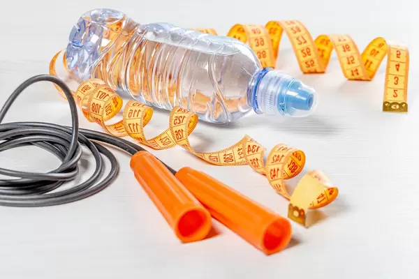 Rope, water bottle and measuring tape on white background. The concept of sports (Flip 2019)