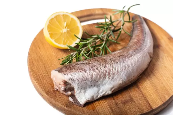 Rosemary and Lemon with Hake fish on the kitchen round cutting board