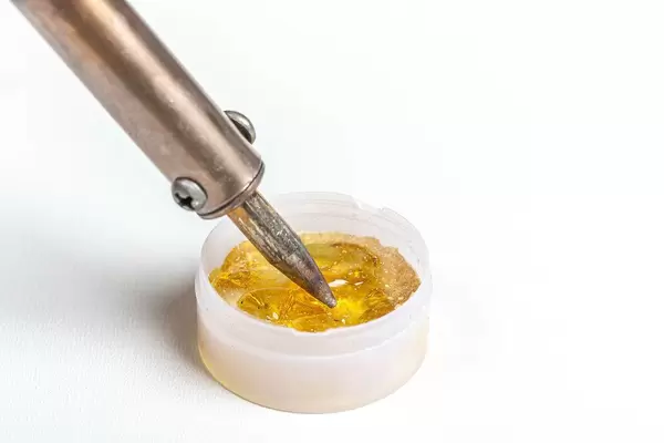 Rosin and soldering iron on white background