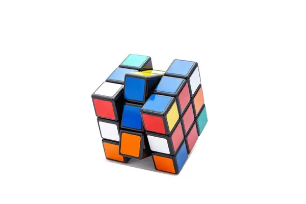 Rotated Rubik's cube 3x3x3 on white background with red and blue lines