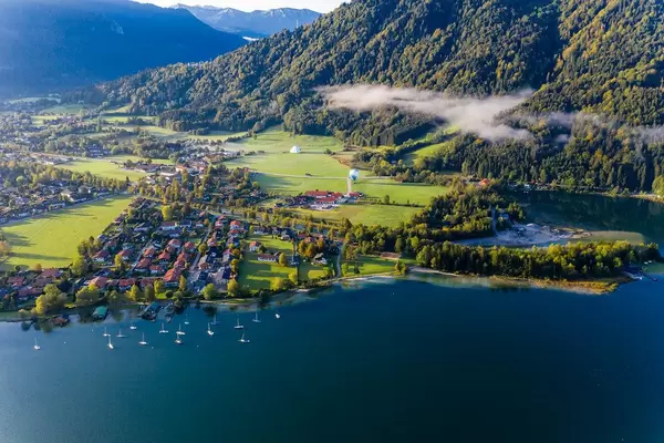 Rottach-Egern (Tegernsee) in autumn light with two hot air balloons at the foot of the Wallberg. Drone pic