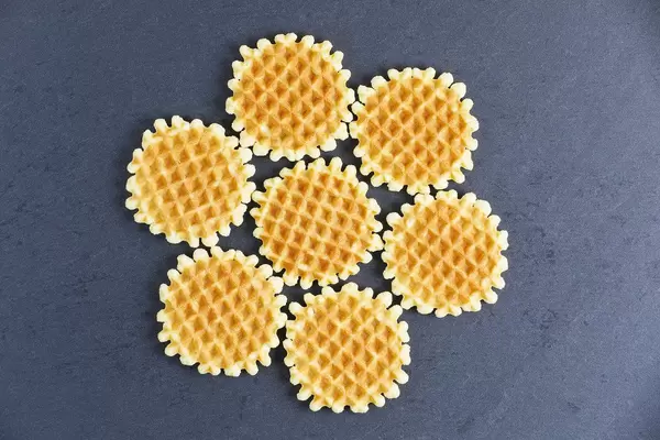 Round Belgian waffles on black background (Flip 2019)