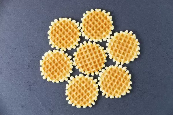 Round Belgian waffles on black background