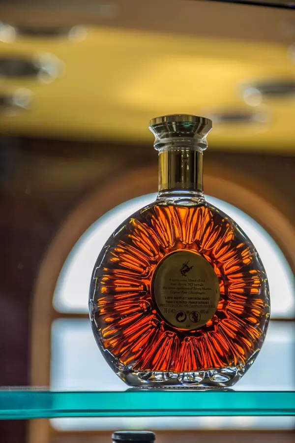 Round bottle in contra light on shelf in the bar