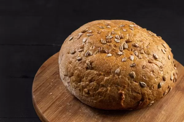 Round bread with Sunflower on the wooden board