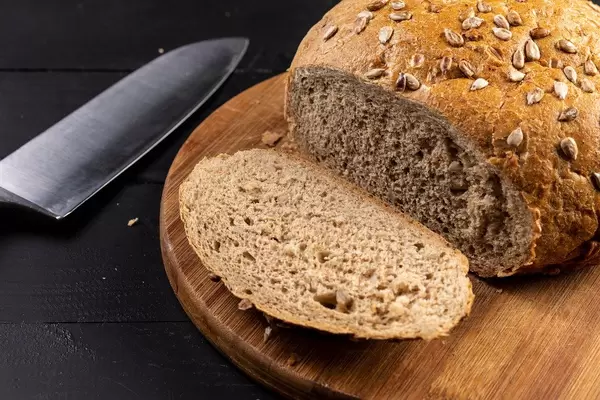 Round bread with Sunflower sliced on the board