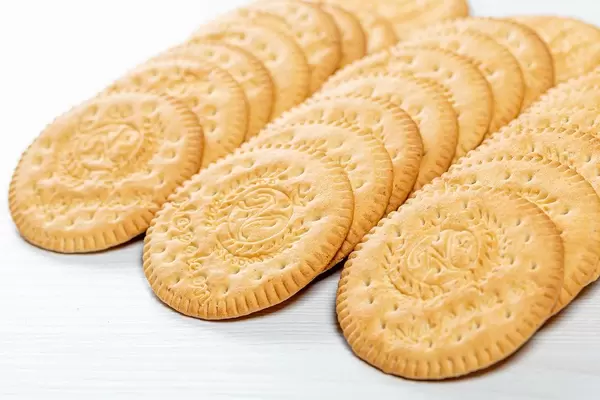 Round cookie on white wooden background