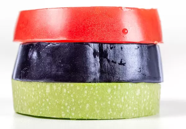 Round slices of eggplant, zucchini and tomato, close-up