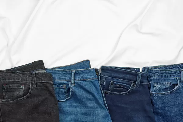 Row of casual jeans pants with copy space