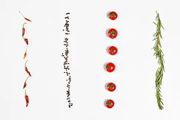 Rows of cherry tomatoes, rosemary, chili peppers and black peppercorn