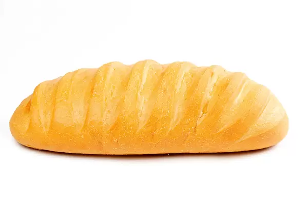 Ruddy long loaf of bread on white background