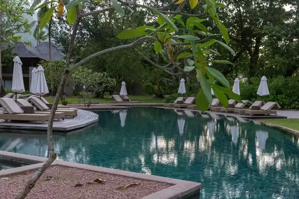 Ruhige Poolanlage mit Sonnenliegen und Sonnenschirmen des Constance Ephelia Resorts, Seychellen