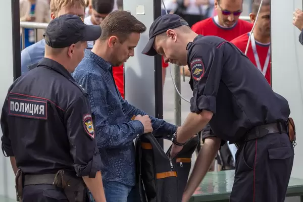 Russian police officers going through a Man's backpack