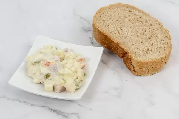 Russian Salad on the plate with bread (Flip 2019)