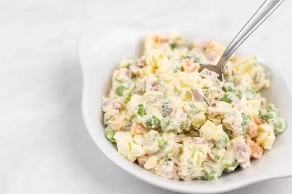 Russian Salad served on the bowl with spoon