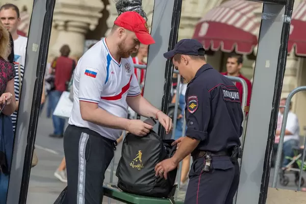Russischer Polizist untersucht den Rucksack eines Fußballfans