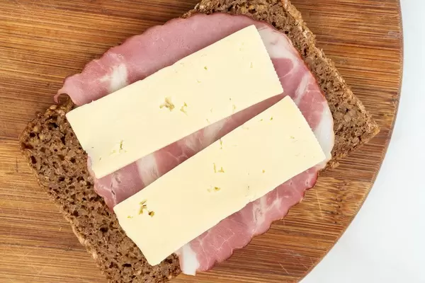 Rye Bread slice with Smoked Pork Neck on the wooden board and cheese (Flip 2019)
