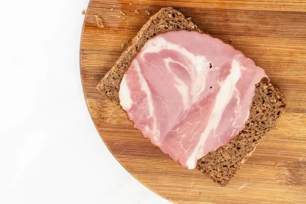 Rye Bread slice with Smoked Pork Neck on the wooden board