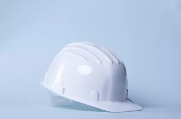 Safety helmet on light blue background