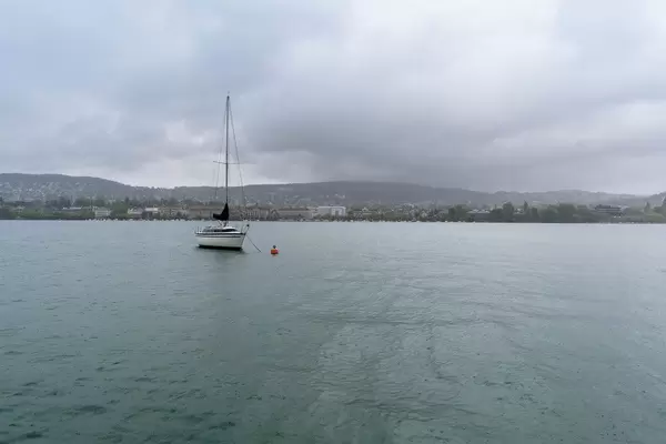 Sail boat moored in front of the city of Zurich
