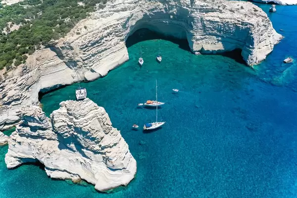 Sailboats and stunning landscape, dream destination in Greece: Kleftiko bay on the island Milos. Drone pic