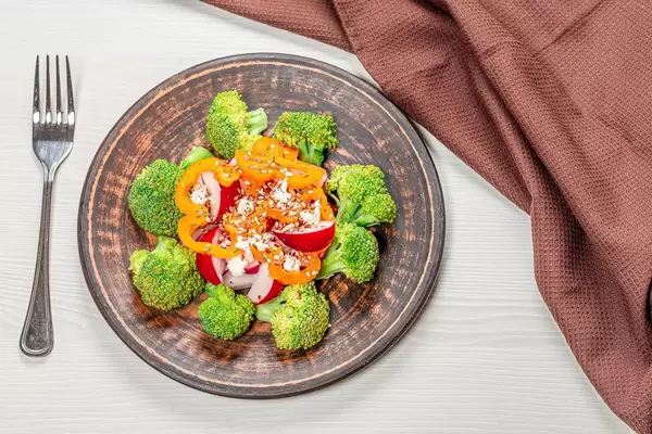 Salad from fresh vegetables with seeds of flax, sesame and poppy. Top view (Flip 2019)