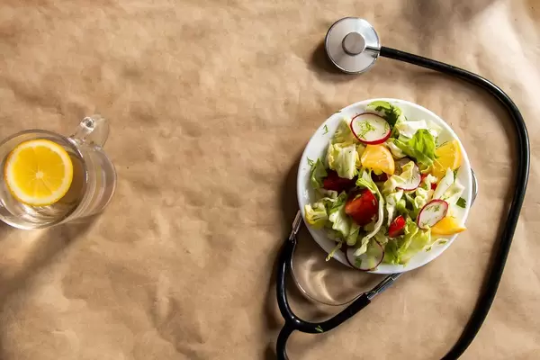 Salad made with fresh vegetables and stethoscope showing healthy eating concept (Flip 2019)