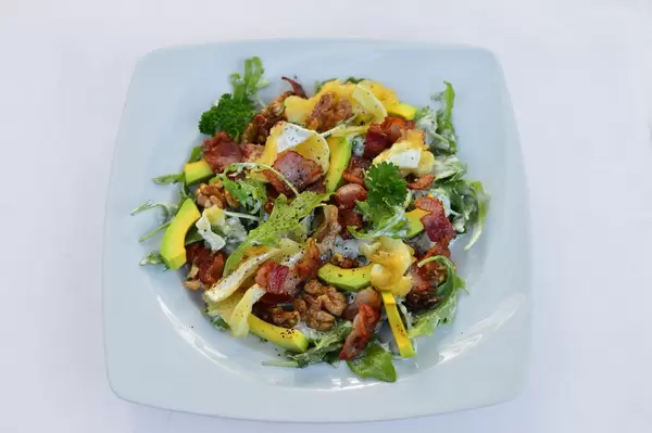 Salad of bacon, arugula, cheese and avocado