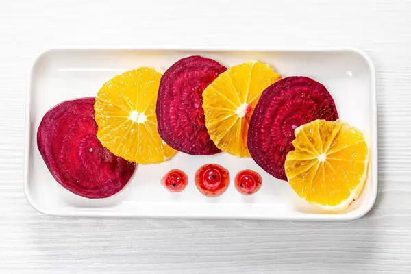 Salad with beets and oranges and berry sauce with red currants. Top view (Flip 2019)