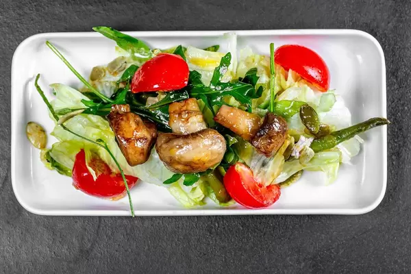Salad with vegetables and mushrooms, top view