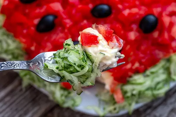 Salad with vegetables, cheese and sauce on a fork closeup (Flip 2019)