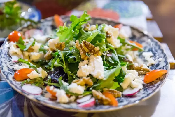 Salad with walnuts, tomatoes, ewes cheese  and radish