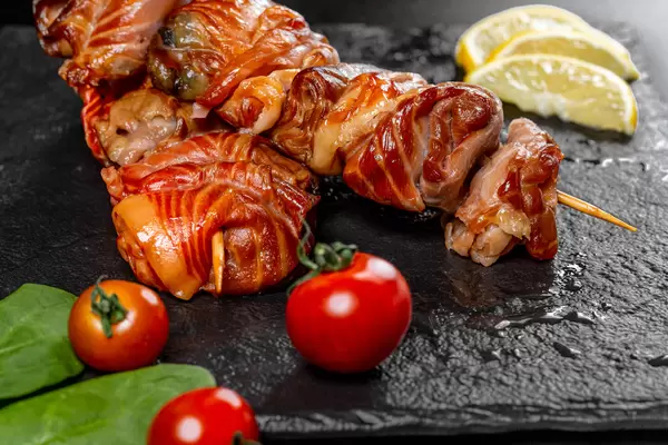 Salmon shashlik on wooden sticks, close-up