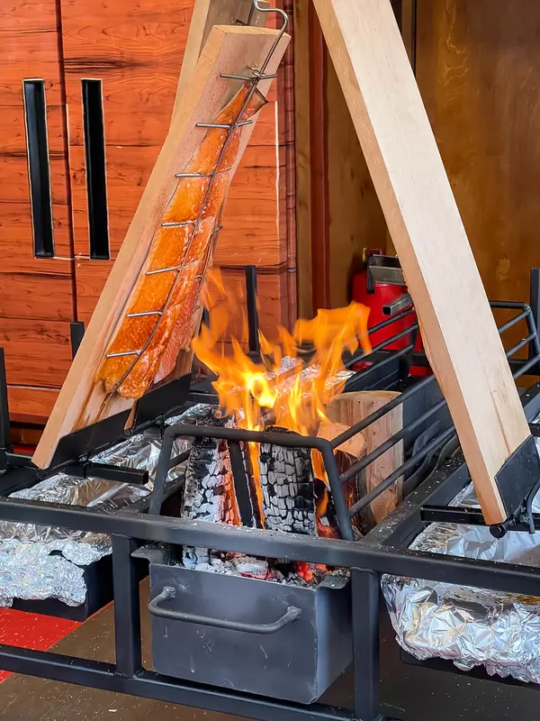Salmon smoked on a wooden plank placed over open fire: traditional method from Finland