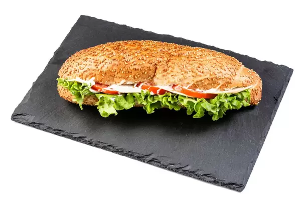 Sandwich with lettuce cheese ham and tomato on black stone tray (Flip 2019)