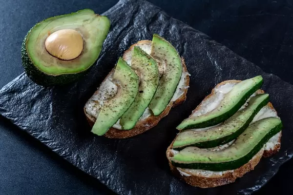 Sandwiches with fresh avocado, cheese and herbs