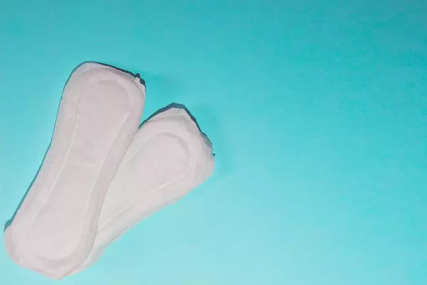 Sanitary napkins on bright background with copy space