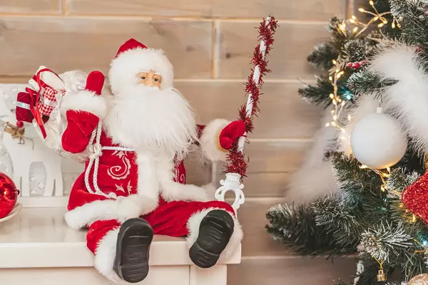 Santa claus toy in christmas interior with christmas tree