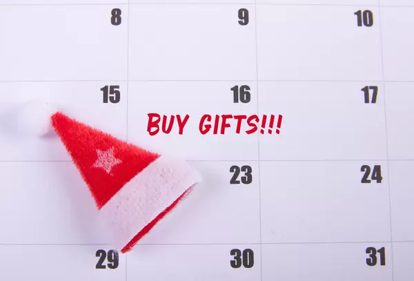 Santas Claus hat and Buy Gifts text on the calendar