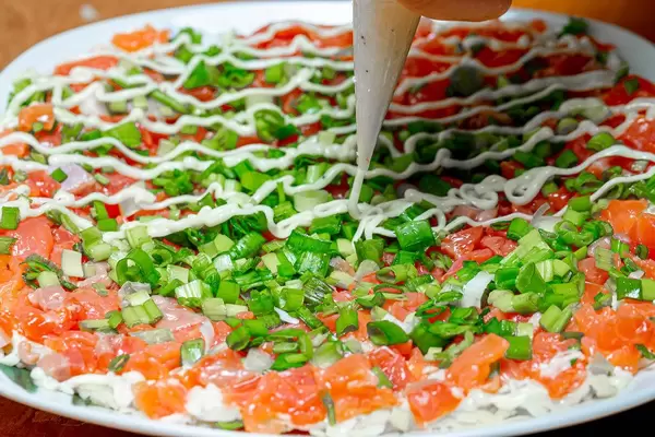 Sauce for salad is squeezed out of a pastry bag (Flip 2020)