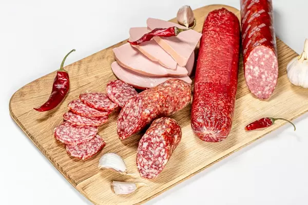 Sausage and salami of different types with chili pepper and garlic
