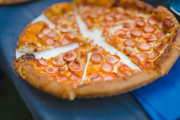 Sausage Pizza Served In Sliced Pieces
