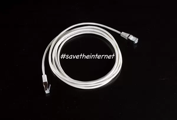 #savetheinternet text with white internet cable on black background