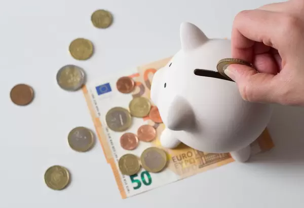 Saving money - cash in euroes with a piggybank