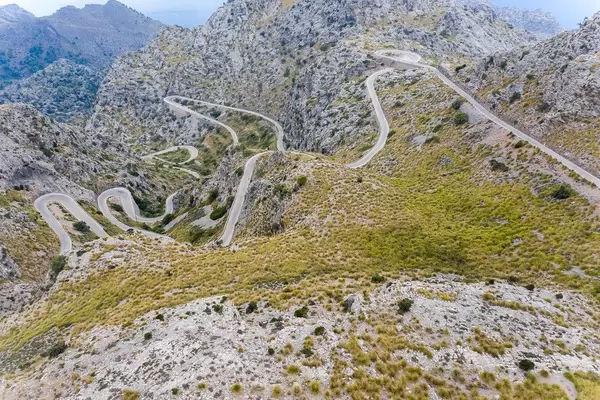 Scary road with many hairpin turns across the Serra de Tramuntana. Carretera de Sa Calobra, drone shot