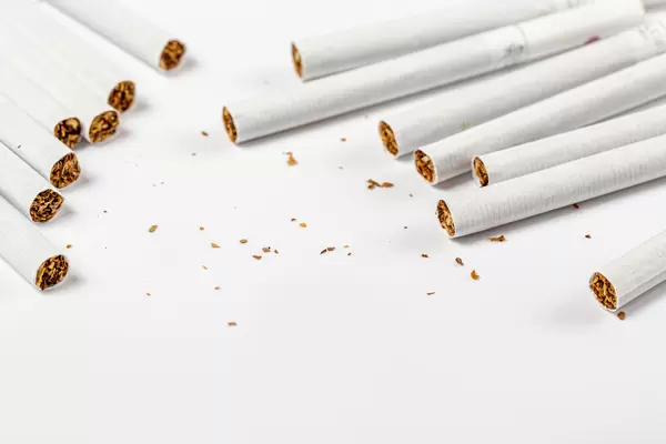 Scattered cigarettes on a white background, concept of harm to health