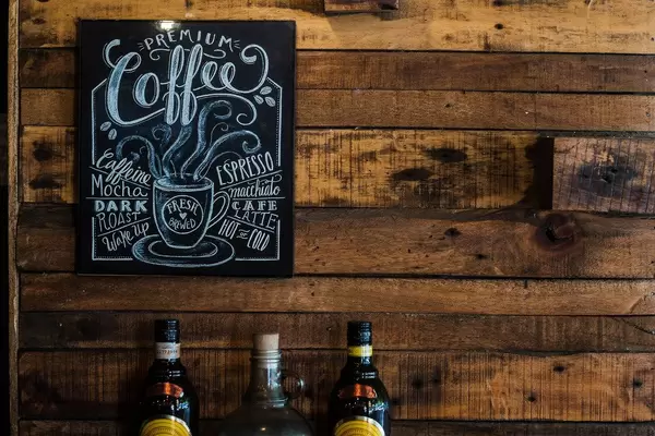 Schild / Tafel in einem Coffeshop and Holzwand mit Spirituosen